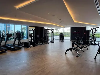 a gym with treadmills and exercise equipment in a building at Opalz Serenity Designer- 1BDR Retreat-07 in Dubai