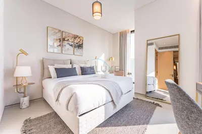 a white bedroom with a large bed and two chairs at Balcony Facing the Marina with Partial Sea Views, Steps from the Beach and a Short Walk to Ain Dubai and Tram, The Address Residences, Jumeirah Beach Residence by Deluxe Holiday Homes in Dubai