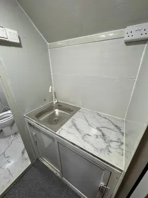 a small bathroom with a marble counter top at dubai camp in ‘Ūd al Bayḑāʼ