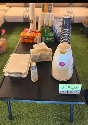 a table with a table with food and a blender at dubai camp in ‘Ūd al Bayḑāʼ