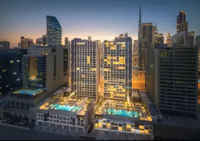 a view of a large city at night at Vogue Downtown The Sterling by Omniyat, near Burj Khalifa and Dubai Mall, Studio Apartment with Balcony and Access to all Amenities in Dubai