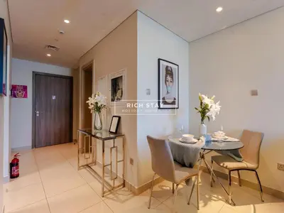 a dining room with a table and chairs at Sway Retreat 1BR Apartment with Burj Khalifa View in Dubai