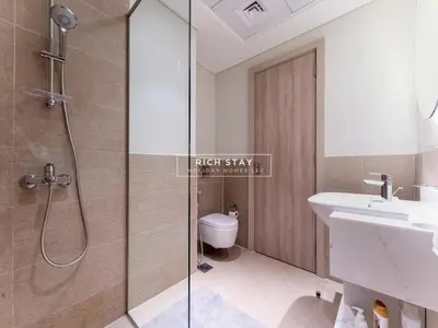 a bathroom with a shower and a sink and a toilet at Sway Retreat 1BR Apartment with Burj Khalifa View in Dubai