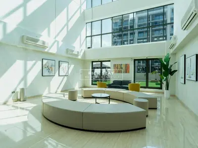 a large living room with a couch and a table at Sway Retreat 1BR Apartment with Burj Khalifa View in Dubai