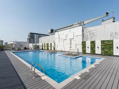 a large swimming pool on top of a building at Sway Retreat 1BR Apartment with Burj Khalifa View in Dubai