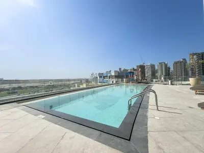 a swimming pool on the roof of a building at Comfortable 2BR Near Downtown by Czechin in Dubai