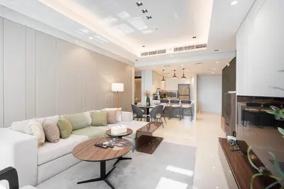 a living room with a white couch and a table at Comfortable 2BR Near Downtown by Czechin in Dubai