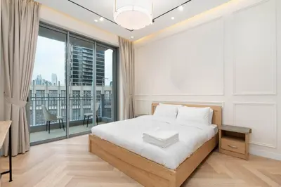 a bedroom with a bed and a large window at Burj Khalifa View 5 Min walk to Dubai Mall in Dubai