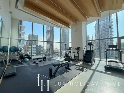 a gym with a view of a city skyline at LUX The Dubai Marina Skyline Suite 2 in Dubai