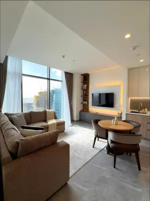 a living room with a couch and a table at Curated High-Floor 1BR Water View Peninsula 1 in Dubai