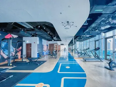 a gym with a lot of treadms and pilates equipment at Vogue Marina Gate near JBR Beach and Marina Mall, One Bedroom Apartment with Balcony and city skyline view, Access to all Amenities in Dubai