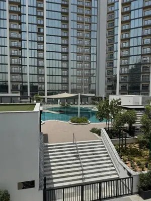 a swimming pool in a city with tall buildings at Gentle brutalism apartments on Sobha Hartland 3BR in Dubai