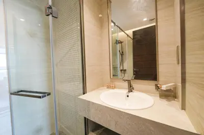 a bathroom with a sink and a shower at Well-Designed Modern 2 BHK Apartment Nobles Tower in Dubai