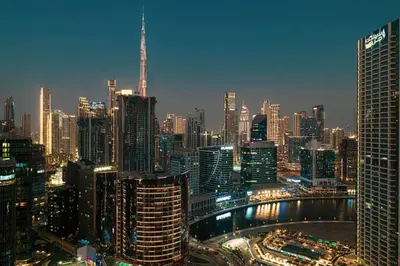 a view of a large city at night at High Rise Premium 2BR apt, PS5, Burj Khalifa view. in Dubai