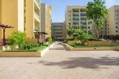 a sidewalk in a city with buildings and trees at Vacationer l Peaceful 2 Bed l Sheikh Zayed Road l The Greens in Dubai