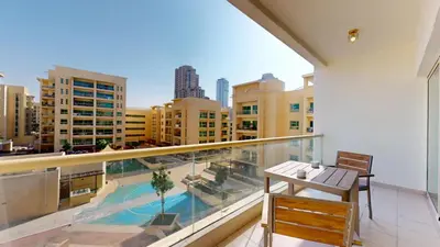 a balcony with a view of a pool and buildings at Vacationer l Peaceful 2 Bed l Sheikh Zayed Road l The Greens in Dubai