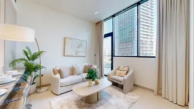 a living room with a couch and a table at Locations l Aesthetic 1 Bed l Own Private Pool l Circle Mall in Dubai