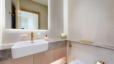 a bathroom with a white sink and a mirror at Locations l Aesthetic 1 Bed l Own Private Pool l Circle Mall in Dubai