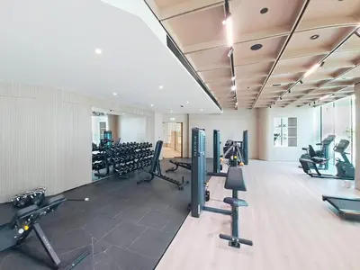 a gym with treadmills and machines in a room at Locations l Aesthetic 1 Bed l Own Private Pool l Circle Mall in Dubai