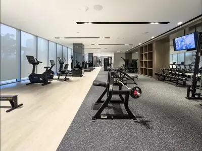 a gym with treadmills and exercise equipment in a building at Signature Luxury Apartments Facing Burj Khalifa in Dubai