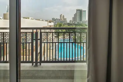 a view of a pool from a balcony at Pool View 2BR with Big Balcony in Dubai