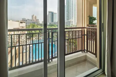 a balcony with a view of a pool at Pool View 2BR with Big Balcony in Dubai