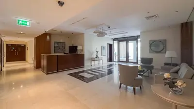a living room with a couch and a table at Pool View 2BR with Big Balcony in Dubai
