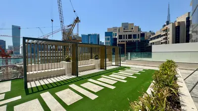 a pavilion on the roof of a building with green grass at Spacious Studio with Balcony & Jacuzzi Trillionaire Residences, Business Bay in Dubai