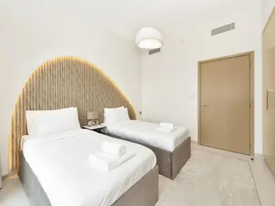 two beds in a hotel room with white walls at Upscale Burj Vista Downtown Stays with Burj Khalifa View in Dubai