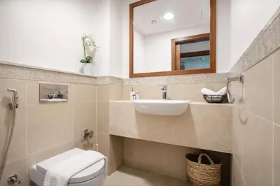 a bathroom with a sink and a toilet and a mirror at Elite Burj Vista Downtown Dubai Apartments with Burj Khalifa View in Dubai