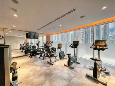 a gym with a bunch of exercise equipment in a building at Elite Burj Vista Downtown Dubai Apartments with Burj Khalifa View in Dubai