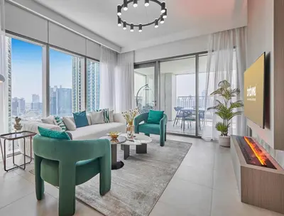 a living room with a couch and chairs and a fireplace at Premium Burj Vista Downtown Apartments with Burj Khalifa View in Dubai