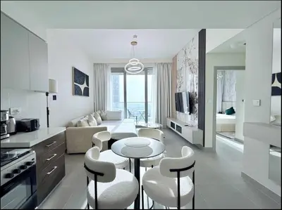 a kitchen and living room with a table and chairs at Premium Burj Vista Downtown Apartments with Burj Khalifa View in Dubai