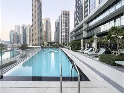 a large swimming pool in a city with tall buildings at Spacious Luxury Apartments at Burj Vista with Direct Burj Khalifa Views in Dubai