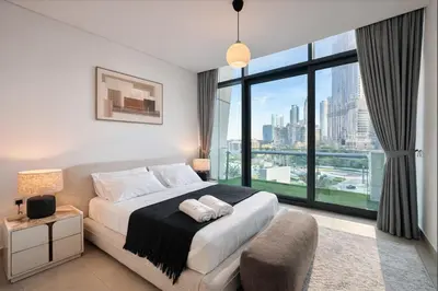 a bedroom with a bed and a large window at Spacious Luxury Apartments at Burj Vista with Direct Burj Khalifa Views in Dubai