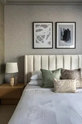a bedroom with a large bed with three pictures on the wall at Exclusive Burj Khalifa View Downtown Burj Vista Apartments in Dubai