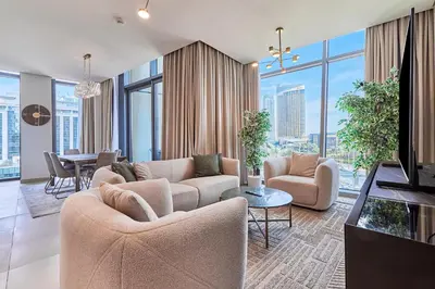 a living room with two couches and a dining room at Burj Khalifa View Apartments, Burj Vista Tower - Downtown in Dubai