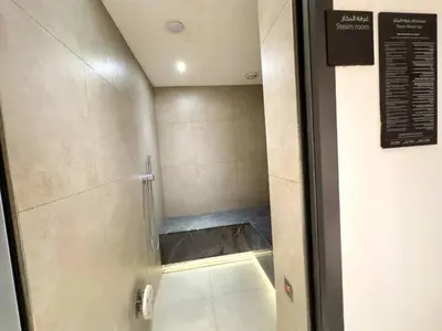 a walk in shower with a glass door in a bathroom at Vogue Downtown Address Residence near Burj Khalifa and Dubai Mall, Two Bedroom Apartment with Balcony and City Skyline view, Access to all Amenities in Dubai