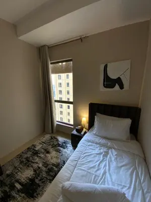 a bedroom with a bed and a window at palm tree Jbr in Dubai