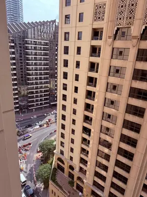 an aerial view of a tall building in a city at palm tree Jbr in Dubai
