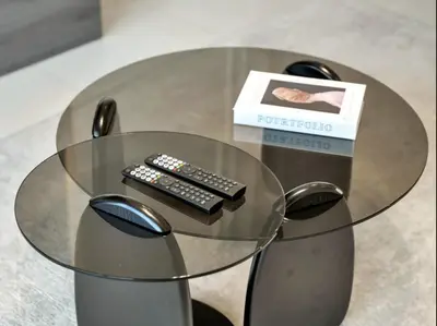 a glass table with two remote controls and a box at Prime Burj Vista Residences with Burj Khalifa View in Dubai