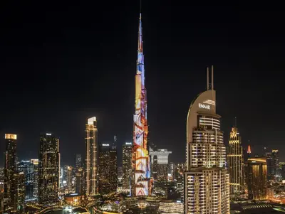 a night view of a city with a tall building at Prime Burj Vista Residences with Burj Khalifa View in Dubai