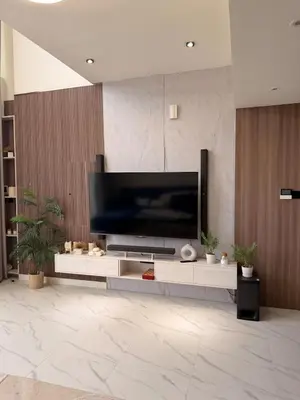 a living room with a large flat screen tv on a wall at Quiet Villa 3 Br in Dubai