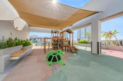 a living room with a green turtle on the floor at Waves - Boho Style Chic Studio With Balcony in JVC in Dubai
