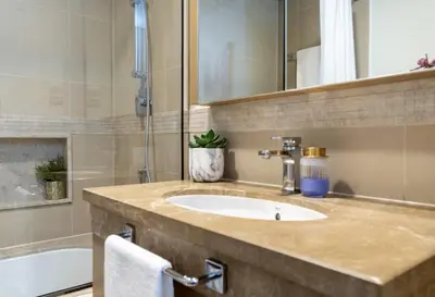 a bathroom with a sink and a bath tub at Grand Burj Vista Downtown Apartment with Burj Khalifa View in Dubai