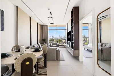 a hotel room with tables and chairs and a living room at Elegant 1BR with Pool Gym & Burj Khalifa Views in Dubai