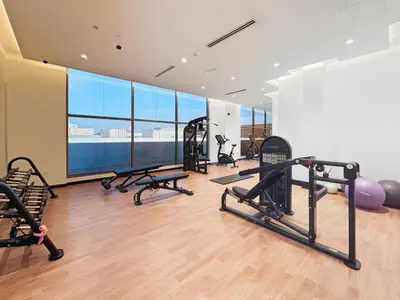 a gym with treadmills and exercise equipment in a building at Elegant 1BR with Pool Gym & Burj Khalifa Views in Dubai