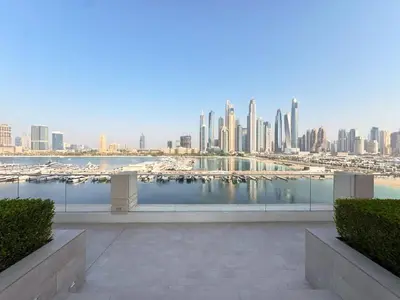 a view of a city with boats in the water at Modern 1BR with Palm View Dubai Harbour in Dubai