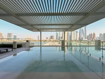 a large swimming pool with a view of a city at Modern 1BR with Palm View Dubai Harbour in Dubai