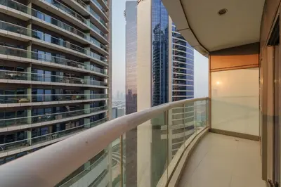 a balcony with a view of a skyscraper at HSHOME - Luxury 3 Bedroom Apartment with Burj Khalifa & Stunning Skyline View in Dubai
